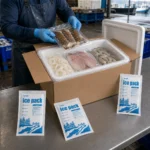 Worker packing fish and shellfish in an EPS-lined seafood shipping box